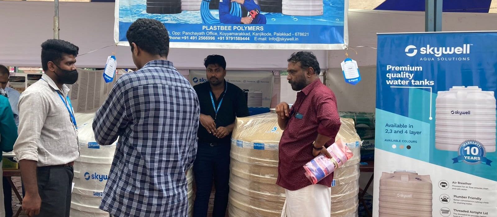 Skywell at AKLWA Palakkad conference, Pattambi, 2022 1 Skywell booth at a conference with water tanks, staff, visitors and product banners.